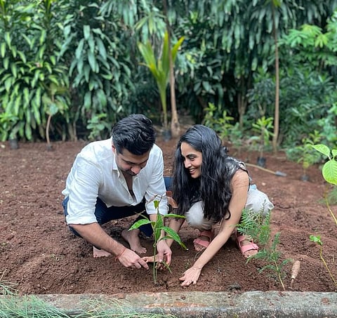 A couple plant saplings before their wedding
